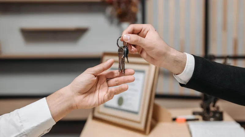 House keys handed over at settlement — the moment the bank's balance is paid before the seller sees a dollar