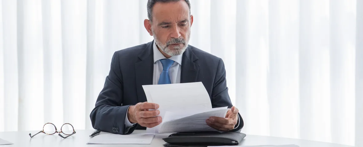 Professional in a city office reviewing an unexpected tax assessment letter, illustrating a Division 293 notice