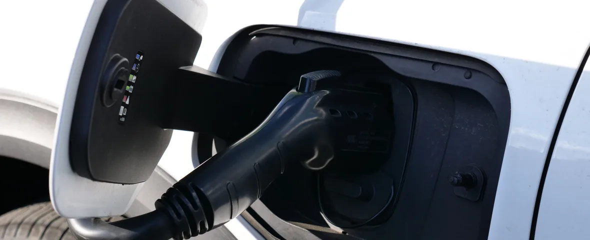 Close-up of a charging cable plugged into an electric vehicle's charging port
