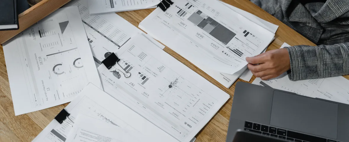 Australian professional reviewing a payslip and annual tax figures at a desk before lodging a return